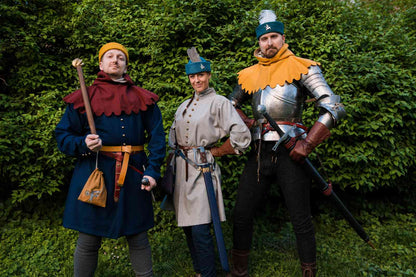 Three medieval warriors in round caps and armor - blue, beige and orange costumes with weapons