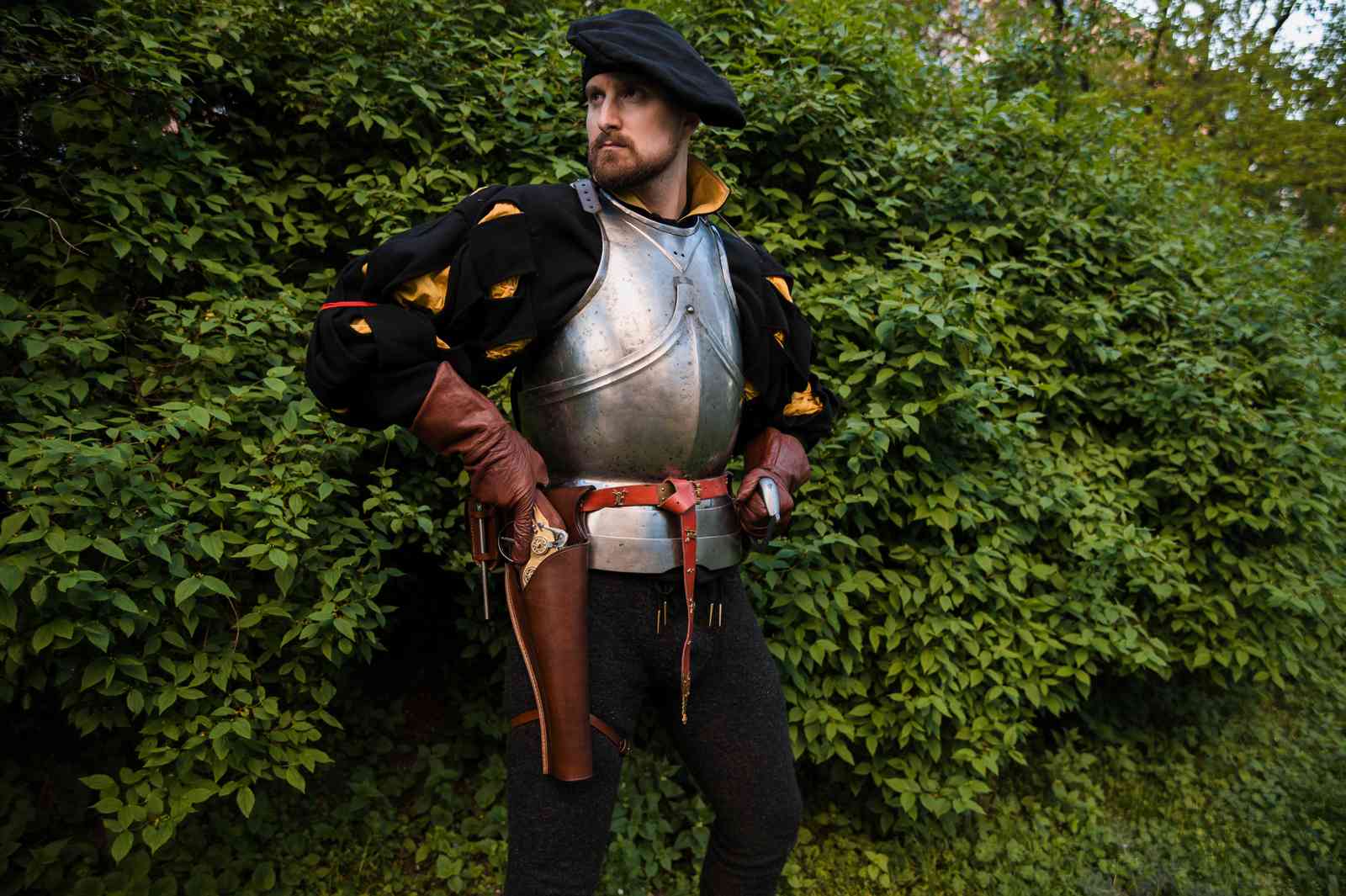 LARP soldier in blackover-under holster close-up detail with brass accents leather armor with over-under holster medieval costume