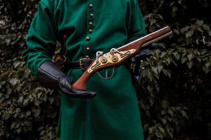 Medieval soldier in teal coat holding wheellock blaster LARP weapon