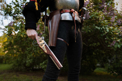 LARP warrior with over-under holster and pistol outdoor closeup