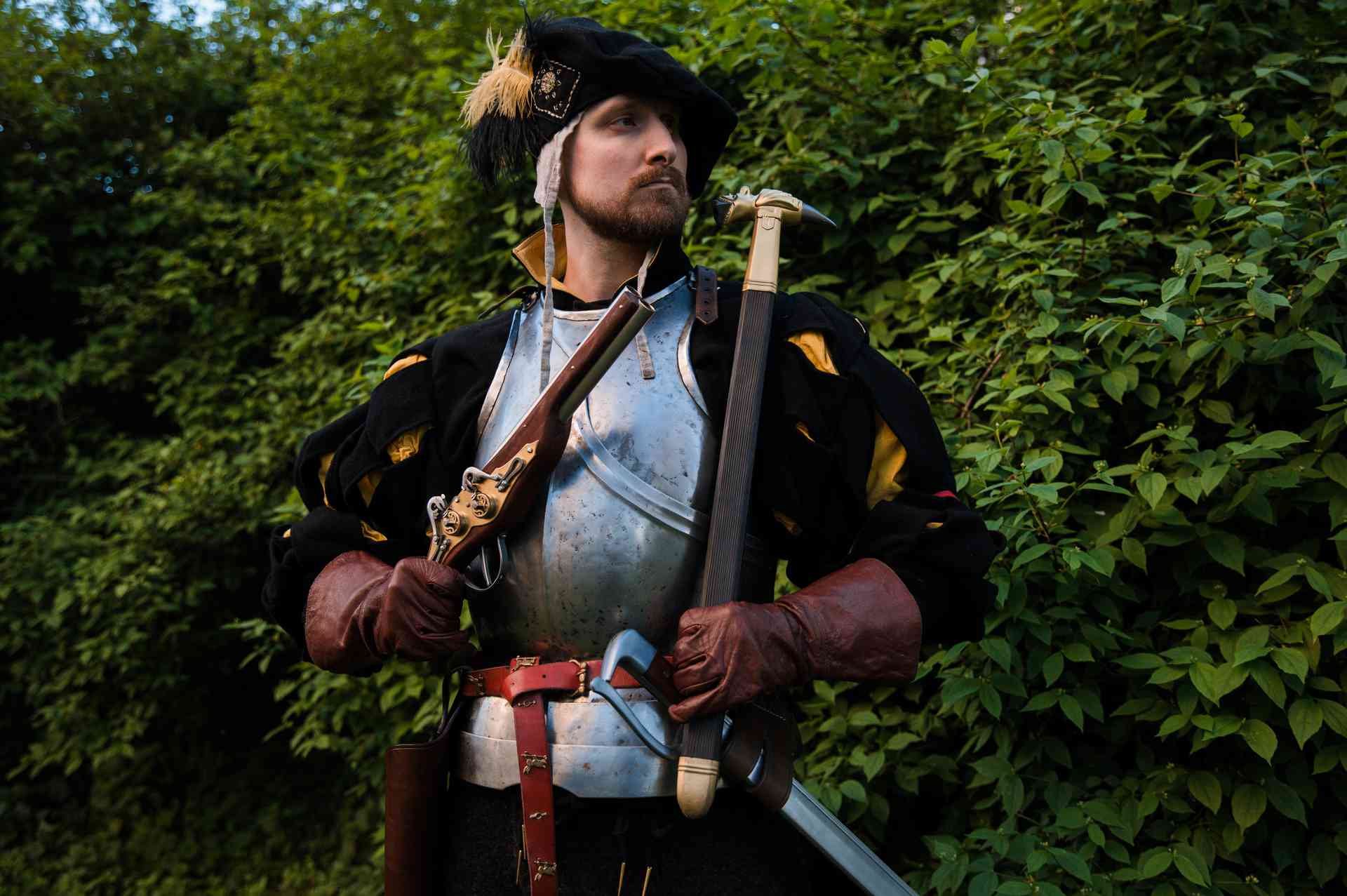 Medieval soldier in armor with wheellock blaster and war hammer medieval LARP weapon