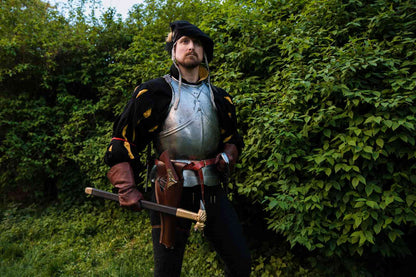 LARP reenactor in full renaissance armor with rapier sword and leather over-under holster medieval costume